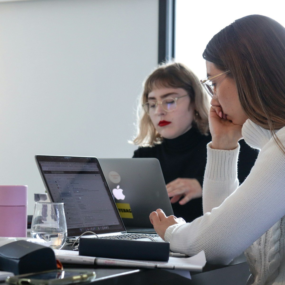 woman in white sweater using laptop computer